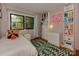 Cozy bedroom with built-in shelving, bright artwork, and large window offering ample sunlight at 6001 Charing Pl, Charlotte, NC 28211