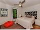 Bright bedroom with unique headboard, modern fan, and cozy beanbag, perfect for relaxation at 6001 Charing Pl, Charlotte, NC 28211