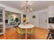 Cozy dining area with a modern chandelier, seating, and hardwood floors at 6001 Charing Pl, Charlotte, NC 28211