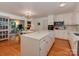 Bright kitchen featuring a large island, stainless steel appliances, and hardwood floors at 6001 Charing Pl, Charlotte, NC 28211