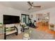Spacious living room with access to the kitchen and outdoor patio, hardwood floors and ceiling fan at 6001 Charing Pl, Charlotte, NC 28211