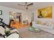 Comfortable living room with hardwood floors, white sofa, and bright open access to the kitchen at 6001 Charing Pl, Charlotte, NC 28211