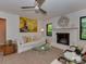 Comfortable living room with fireplace, neutral decor, ceiling fan and lots of natural light at 6001 Charing Pl, Charlotte, NC 28211