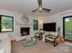 Spacious living room with fireplace, with neutral decor and access to the backyard at 6001 Charing Pl, Charlotte, NC 28211