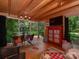 Bright, wood-clad living room with ample windows and backyard views, seamlessly blending indoor and outdoor spaces at 6001 Charing Pl, Charlotte, NC 28211
