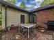 Outdoor patio with a brick surface, dining table, and a grill, perfect for entertaining guests at 6001 Charing Pl, Charlotte, NC 28211