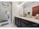 Modern bathroom features a double vanity, quartz countertop, and glass enclosed shower at 614 West End Dr, Charlotte, NC 28208