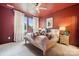 Bedroom with red ceiling and walls, carpet floors, and bright natural light from the windows at 614 West End Dr, Charlotte, NC 28208