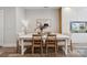Elegant dining room with a modern white table, seating for six, and beautiful wood floors, great for entertaining at 614 West End Dr, Charlotte, NC 28208