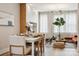 Bright dining area boasts a sleek white table with seating for six, open to the well-lit living space at 614 West End Dr, Charlotte, NC 28208