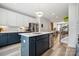 Modern kitchen with stainless steel appliances, large island, and views to dining area and staircase at 614 West End Dr, Charlotte, NC 28208