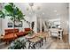Inviting living area with a plush rust-colored sofa, open floor plan, and staircase, perfect for entertaining guests at 614 West End Dr, Charlotte, NC 28208