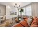 Open-concept living area with a comfortable sofa, chic decor, a flat-screen TV and lots of natural light at 614 West End Dr, Charlotte, NC 28208
