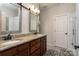 Bathroom with granite counters, dual sinks, sliding barn door style mirrors and updated fixtures at 6398 Winding Creek Ln, Denver, NC 28037