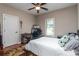Bedroom featuring a queen bed, ceiling fan, and neutral decor with a view to the outdoors at 6398 Winding Creek Ln, Denver, NC 28037