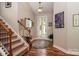 Inviting entryway with hardwood floors, staircase, overhead lighting, and decorative accents at 6398 Winding Creek Ln, Denver, NC 28037