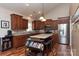 Bright kitchen with granite countertops, a center island, stainless steel appliances, and a vaulted ceiling at 6398 Winding Creek Ln, Denver, NC 28037