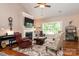 Comfortable living room with a fireplace, ceiling fan, large window, and stylish decor at 6398 Winding Creek Ln, Denver, NC 28037