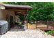 View of the outdoor space with brick patio, covered deck with ceiling fan, lounge furniture, and a grill at 6398 Winding Creek Ln, Denver, NC 28037