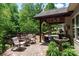Outdoor patio with seating area, water feature, and wooded views covered by the patio roof at 6398 Winding Creek Ln, Denver, NC 28037