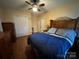 Comfortable bedroom with hardwood floors, featuring a ceiling fan and an inviting bed at 66 Arlington Se Ave, Concord, NC 28025