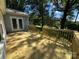 New wooden deck overlooking a grassy backyard with a calming green chair at 66 Arlington Se Ave, Concord, NC 28025