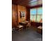 Cozy dining room showcasing wood paneling, natural light, and a wooden dining table set for a meal at 66 Arlington Se Ave, Concord, NC 28025