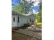 Exterior view of home's side with a light blue facade, walkway, and yard at 66 Arlington Se Ave, Concord, NC 28025
