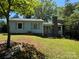 Light blue single-Gathering home with gray shutters and a stone chimney at 66 Arlington Se Ave, Concord, NC 28025