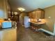Functional kitchen featuring wooden cabinets, a tiled floor, and a built-in breakfast bar for convenient dining at 66 Arlington Se Ave, Concord, NC 28025