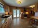 Spacious kitchen with tiled floor, wood cabinets, and access to outdoor deck at 66 Arlington Se Ave, Concord, NC 28025