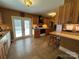 The warm-toned kitchen features wood cabinets, tiled floor, and natural light at 66 Arlington Se Ave, Concord, NC 28025