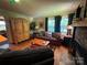Comfortable living room with hardwood floors, a stone fireplace, and large window at 66 Arlington Se Ave, Concord, NC 28025