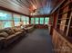 Wood-paneled living room with abundant natural light, built-in shelves, and comfortable seating arrangement at 66 Arlington Se Ave, Concord, NC 28025