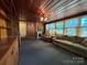 Spacious living room with wood paneling, large windows, comfortable seating, and a decorative fireplace at 66 Arlington Se Ave, Concord, NC 28025