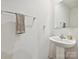 A half bathroom featuring a pedestal sink and towel rack at 665 Pointe Andrews Dr, Concord, NC 28025
