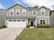 Charming two-story home featuring vinyl siding, a well-maintained lawn, and a two-car garage at 665 Pointe Andrews Dr, Concord, NC 28025