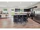 Kitchen with stainless steel appliances, dark cabinetry, and an island with bar stool seating at 665 Pointe Andrews Dr, Concord, NC 28025