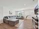 Comfortable living room featuring a large sectional sofa, modern entertainment center, and plenty of natural light at 665 Pointe Andrews Dr, Concord, NC 28025