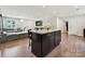 Open-concept living space featuring a kitchen island, cozy living area, and modern flooring at 665 Pointe Andrews Dr, Concord, NC 28025