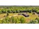 Beautiful aerial view of house and detached garage surrounded by lush forest and expansive lot at 725 Hunters Ridge Rd, Taylorsville, NC 28681