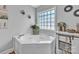 Bright bathroom featuring a soaking tub and charming decor for a relaxing spa-like experience at 725 Hunters Ridge Rd, Taylorsville, NC 28681