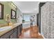 Primary bathroom showcases modern dual vanity, bath tub, hardwood flooring and a shower with a curtain at 725 Hunters Ridge Rd, Taylorsville, NC 28681