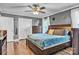 Comfortable bedroom boasts hardwood floors, modern ceiling fan, neutral wall color and a closet at 725 Hunters Ridge Rd, Taylorsville, NC 28681