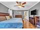 Bright bedroom featuring hardwood floors, neutral wall color and a flat screen TV at 725 Hunters Ridge Rd, Taylorsville, NC 28681