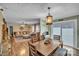 Cozy dining area flows into living space, featuring hardwood floors and inviting natural light from sliding glass doors at 725 Hunters Ridge Rd, Taylorsville, NC 28681