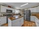 Modern kitchen with stainless steel appliances, center island, and white cabinetry at 725 Hunters Ridge Rd, Taylorsville, NC 28681