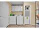 Functional laundry room with white washer and dryer set, storage cabinets, and ample space for organization at 725 Hunters Ridge Rd, Taylorsville, NC 28681