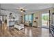 Cozy living room with hardwood floors, white shiplap accent wall, and natural light at 725 Hunters Ridge Rd, Taylorsville, NC 28681