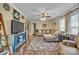 Spacious living room features a comfortable sectional sofa, large rug, hardwood floors and plenty of natural light at 725 Hunters Ridge Rd, Taylorsville, NC 28681